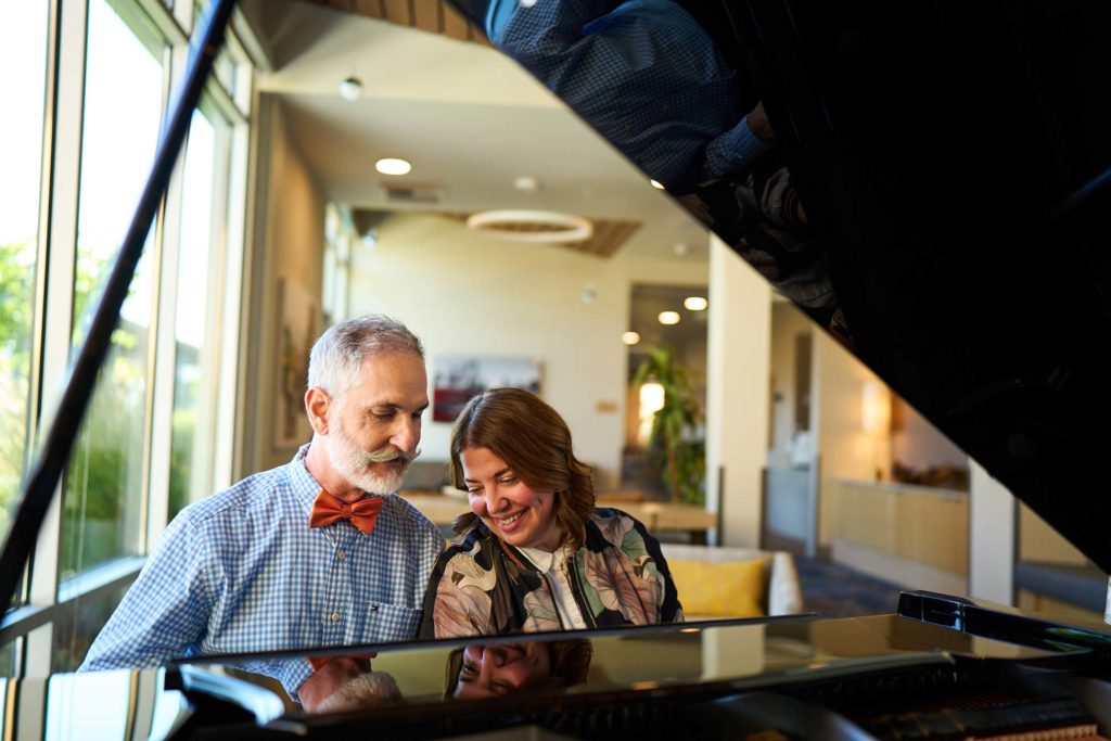 Dad and daughter playing piano