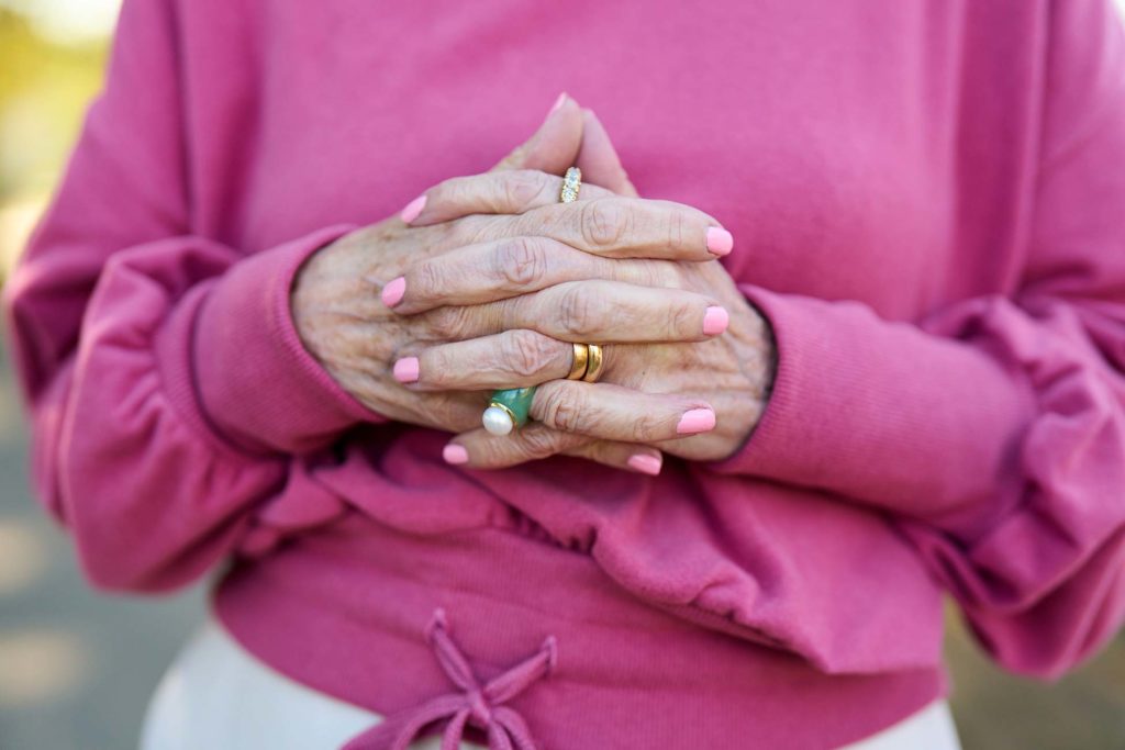 Senior with hands clasped