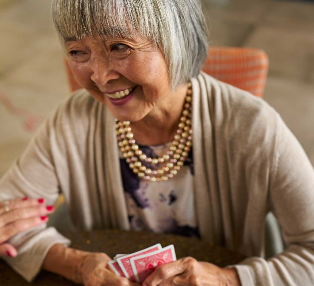 Senior woman playing cards