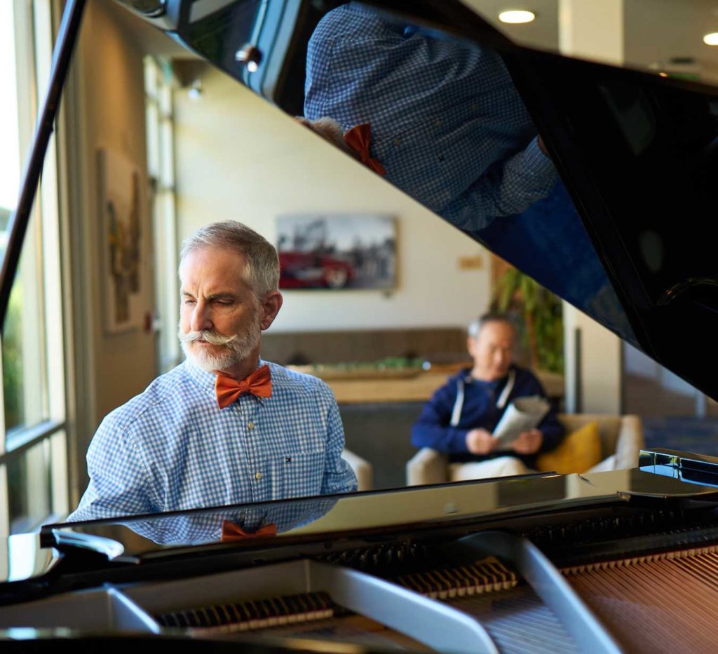 Senior man playing on piano