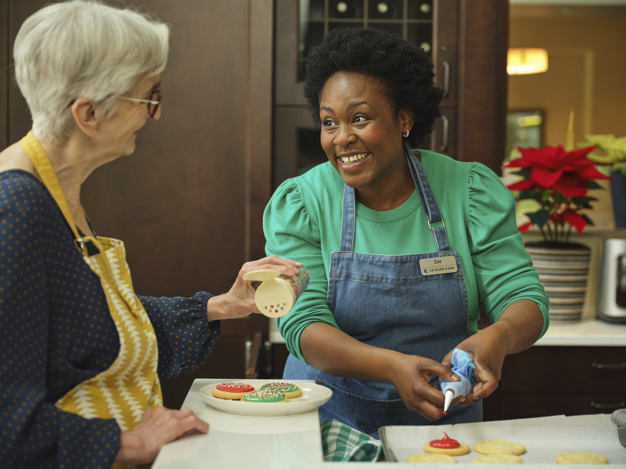 Two senior women communicate while drinking tea